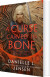 A Curse Carved In Bone - English Book